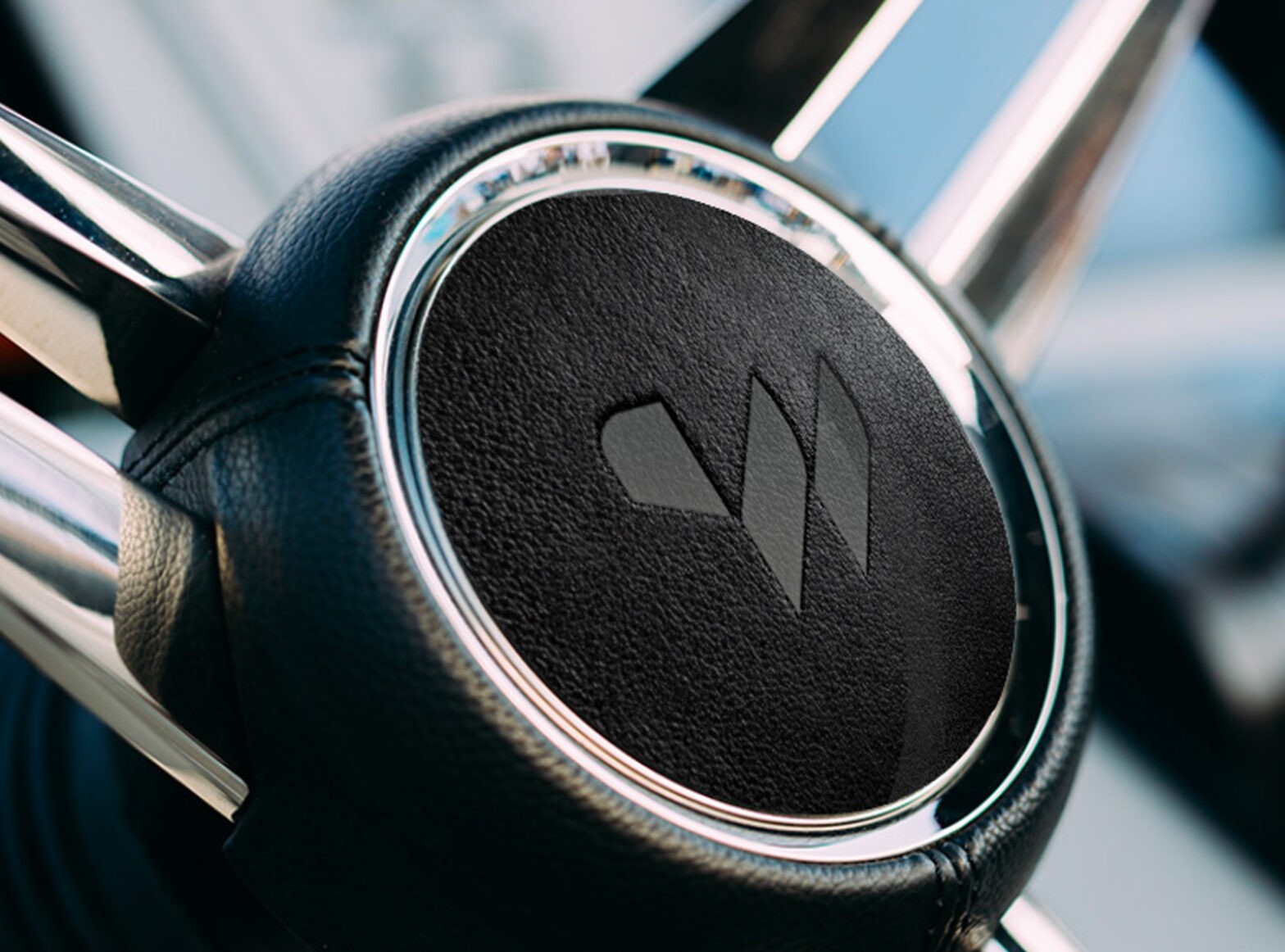 Close-up of Williams Jet Tender's steering wheel with the company's logo prominently displayed.